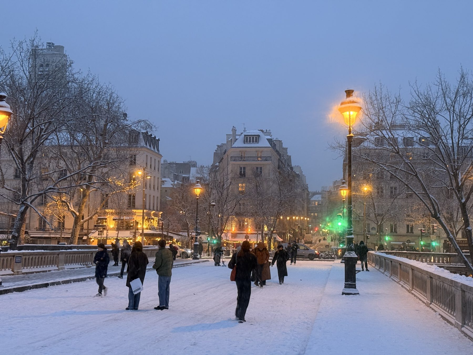 A snowy Paris street at dusk